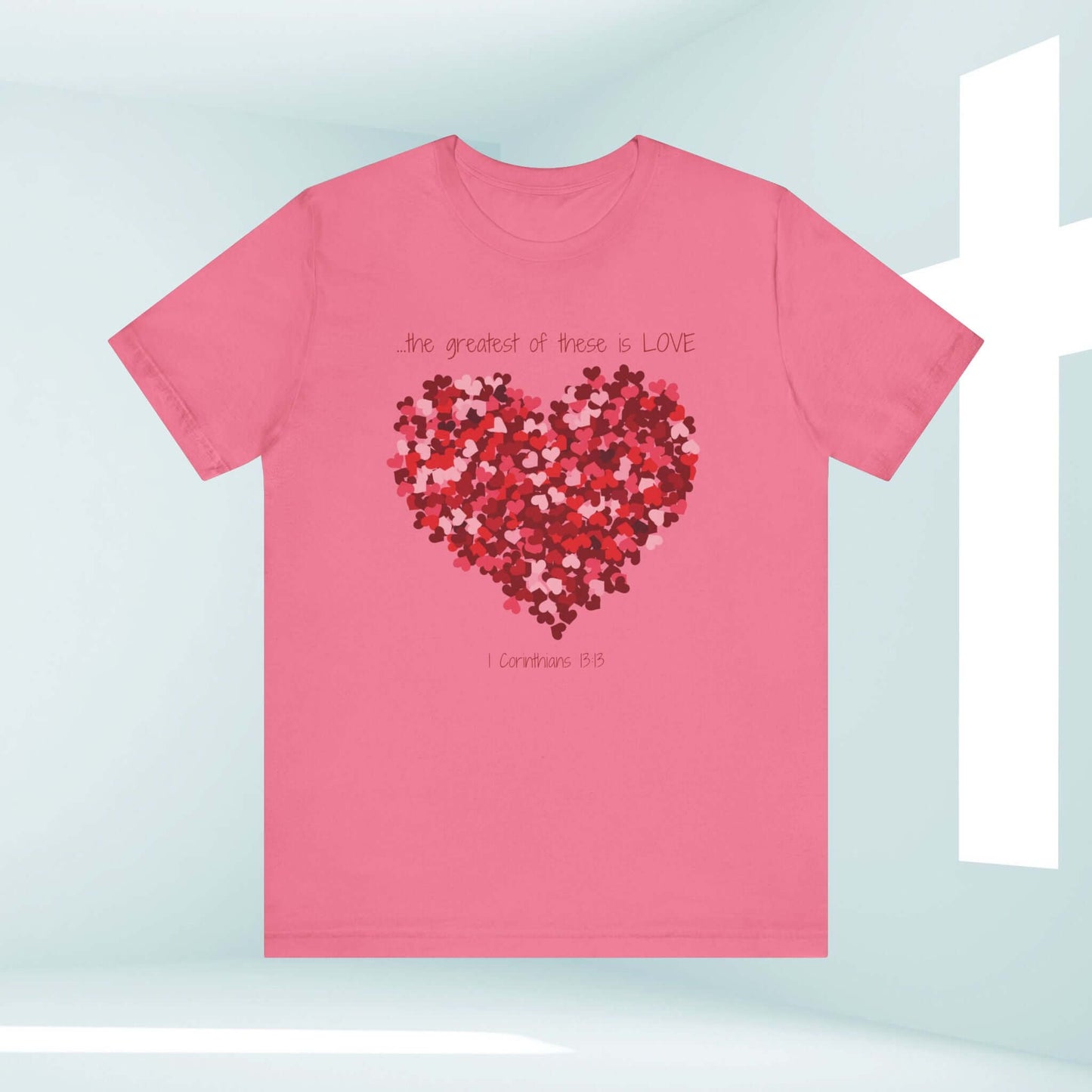 Pink Christian Valentine's Day t-shirt with heart design and "the greatest of these is love" quote for wedding or anniversary gift.