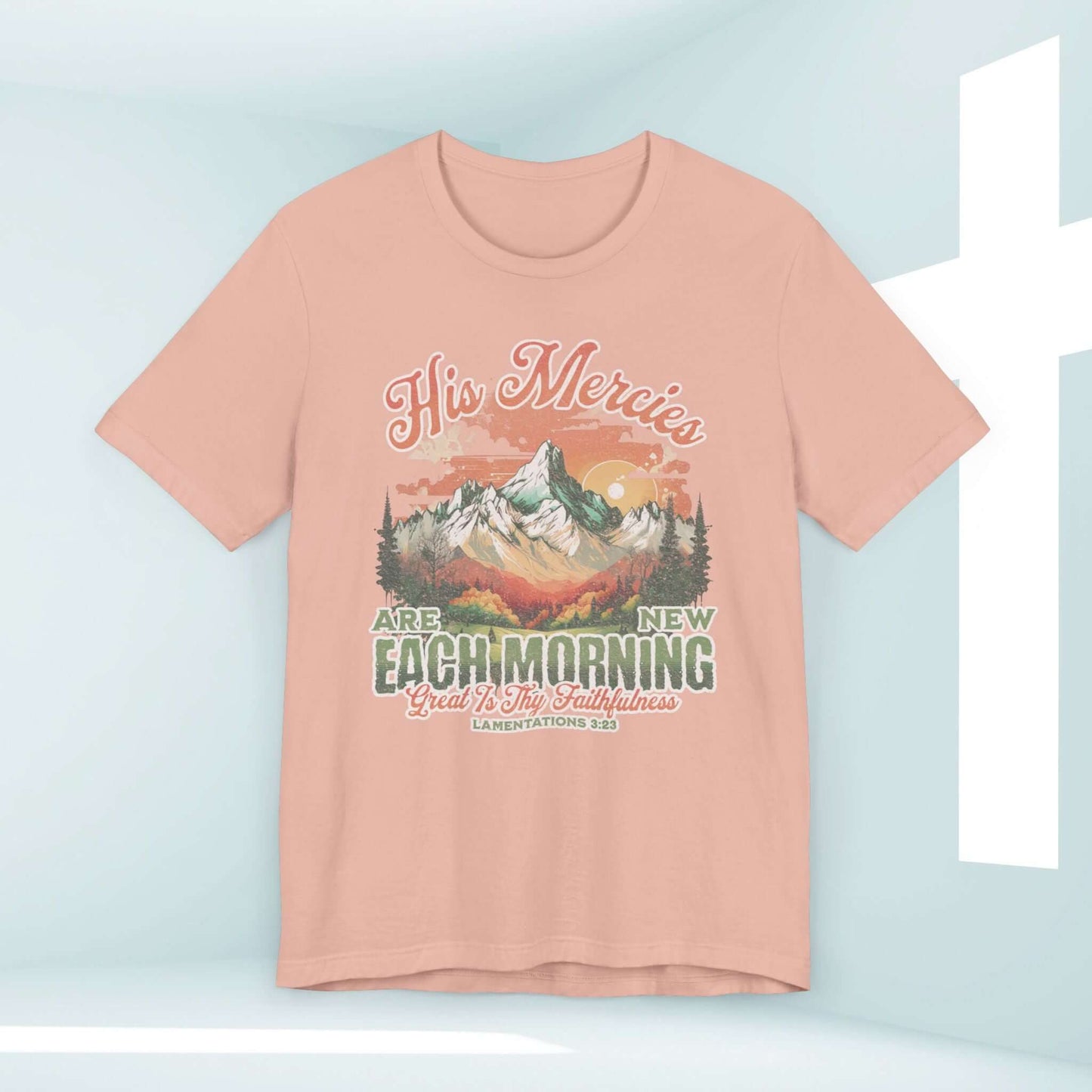 Boho Christian shirt in peach with "His Mercies Are New Each Morning" Bible verse and mountain design, perfect for Christian apparel.