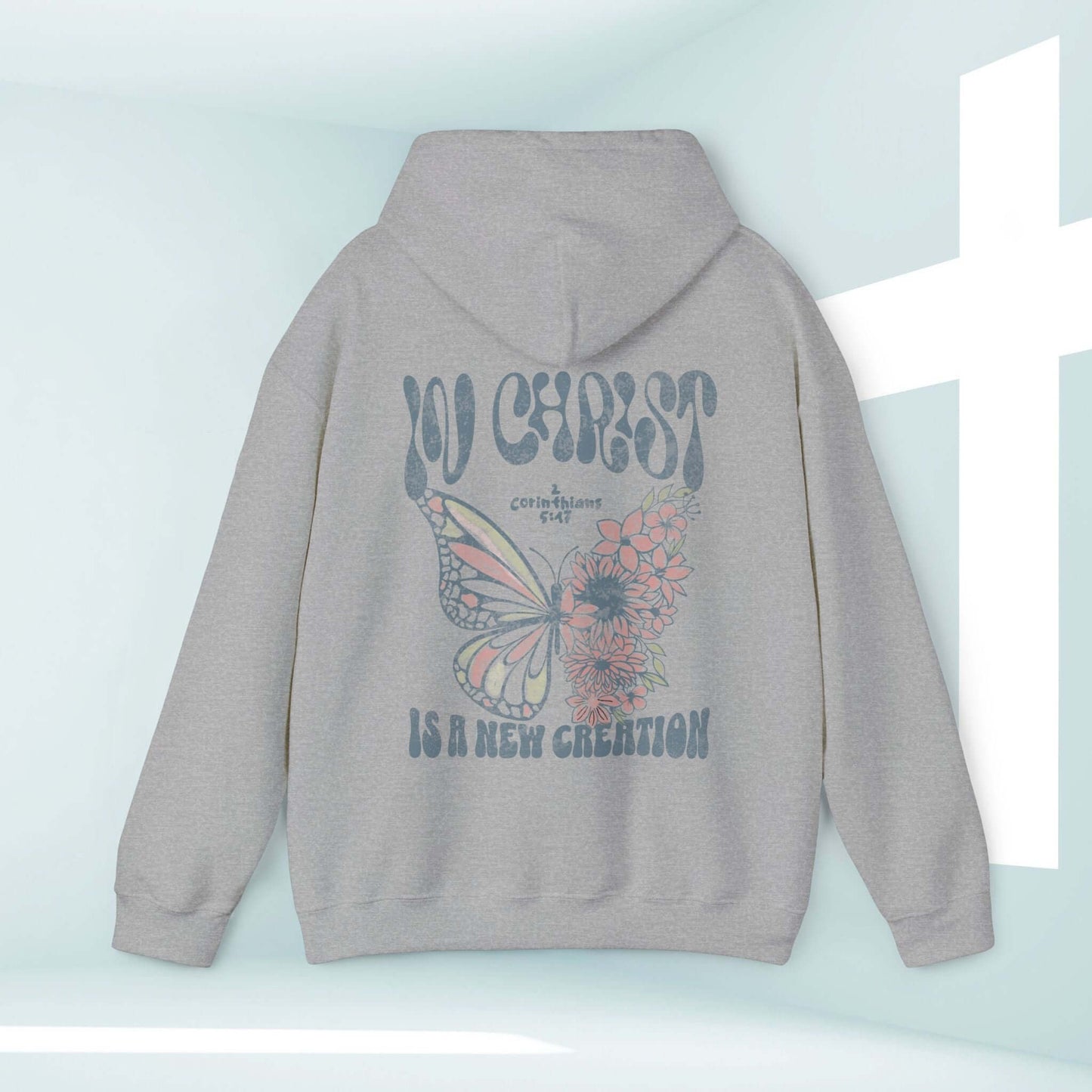 Christian hoodie with butterfly graphic and "In Christ Is A New Creation" Bible verse, inspirational faith-based apparel.