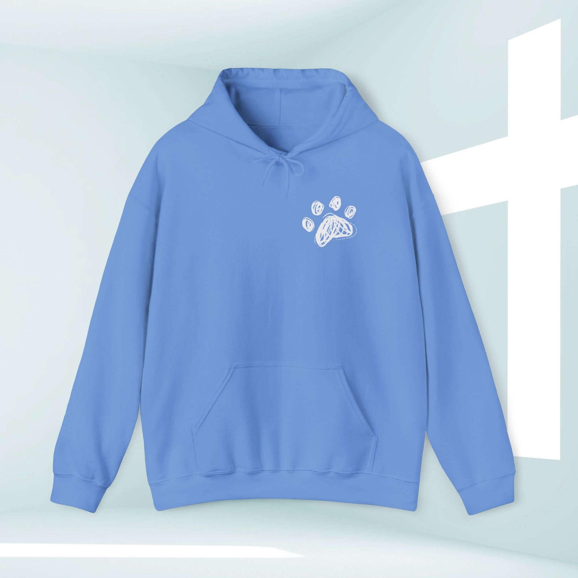 Light blue Christian hoodie with paw print graphic, symbolizing "I Pray With My Dog" message, perfect for dog lovers and faithful followers.