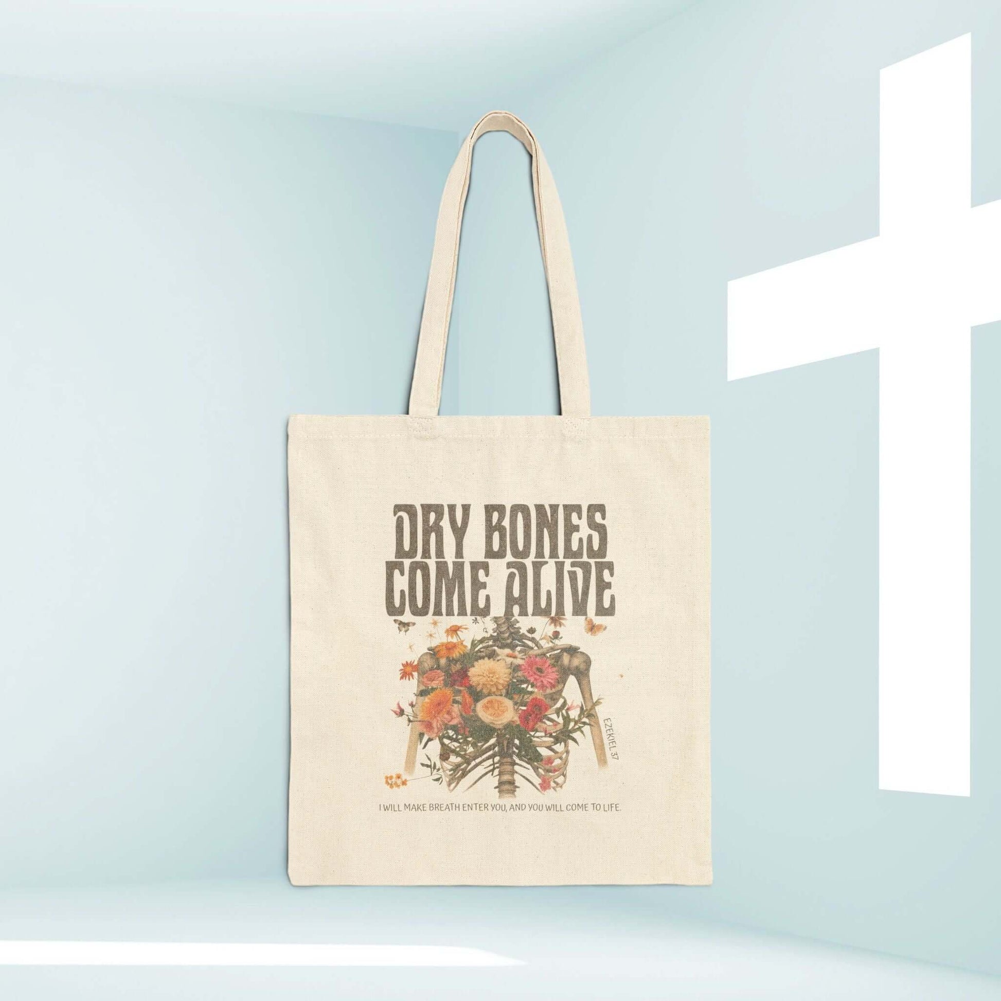 Christian Halloween tote bag with "Dry Bones Come Alive" design featuring flowers and skeleton, religious trick or treat accessory.