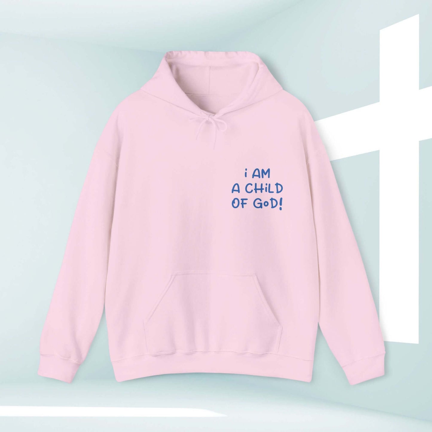 Pale pink "I Am A Child Of God" Christian hoodie with spacious kangaroo pocket and double-lined hood, set against a light background with a white cross.