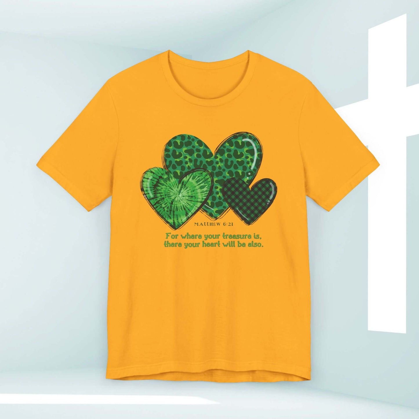 Christian St Patrick's Day shirt with green shamrock hearts and Bible verse Matthew 6:21 in a bright yellow color, perfect for St Patty's celebrations.