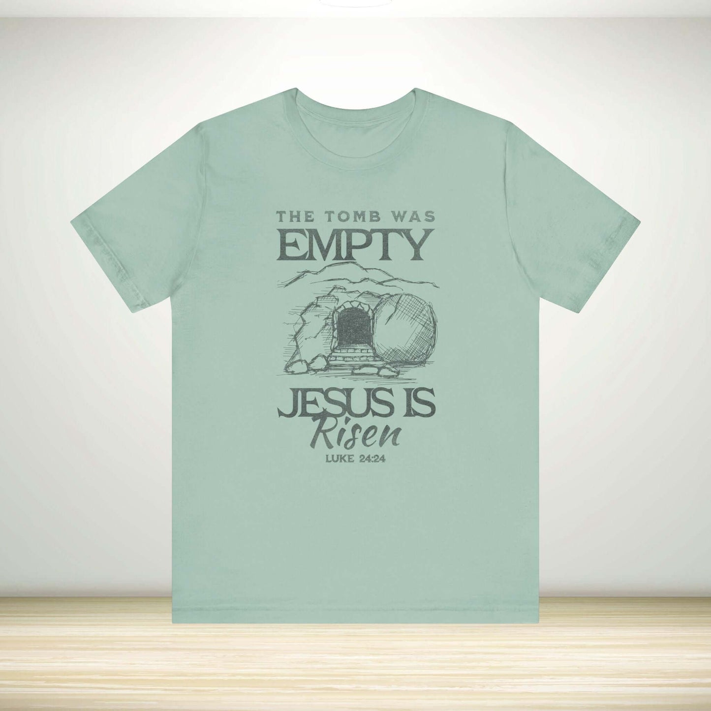 Christian Easter tee with "The Tomb Was Empty Jesus Is Risen" design, Bible verse Luke 24:24, religious Easter clothing.