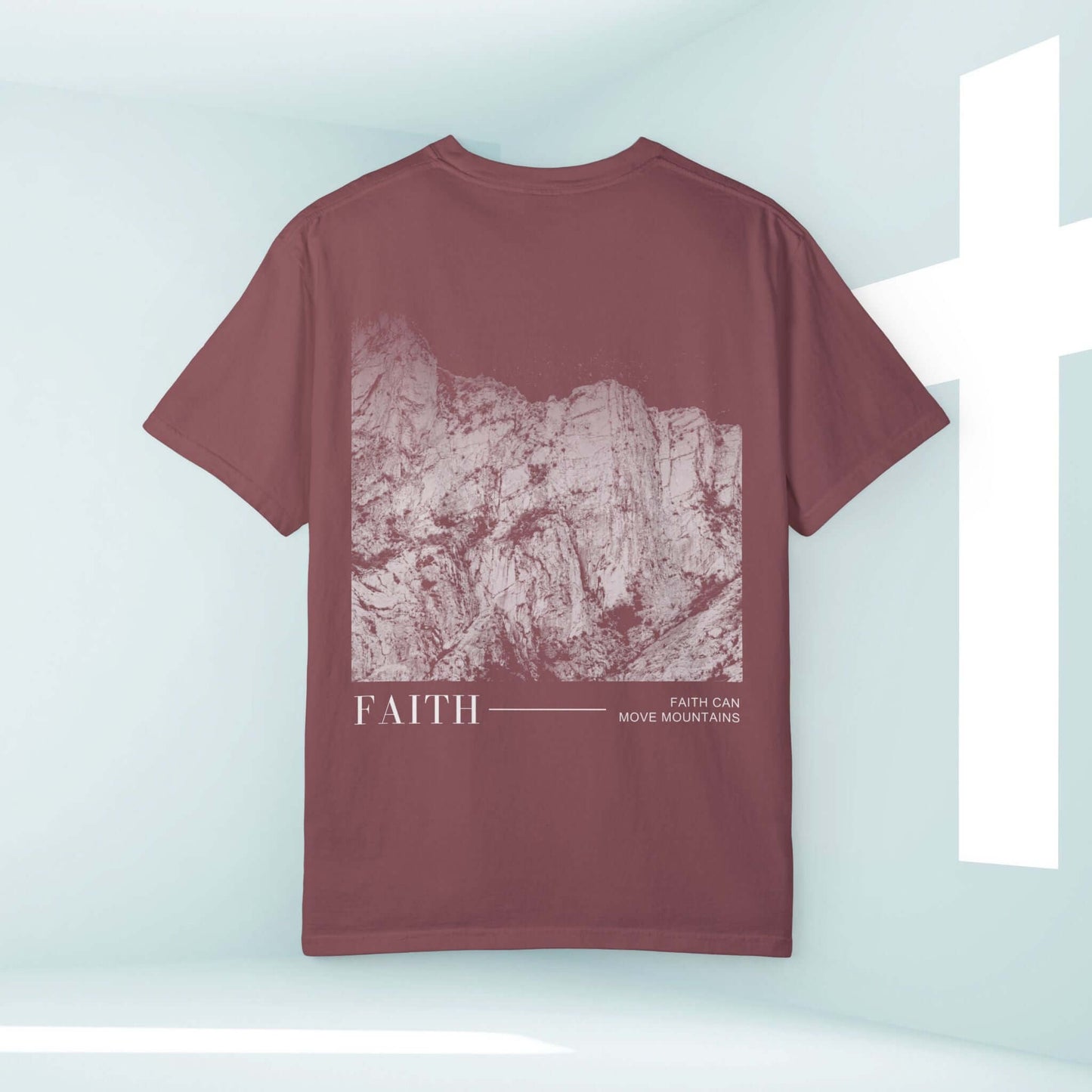 "Faith Can Move Mountains Christian t-shirt with mountain graphic, bible verse, and cross in background - inspirational Christian apparel"