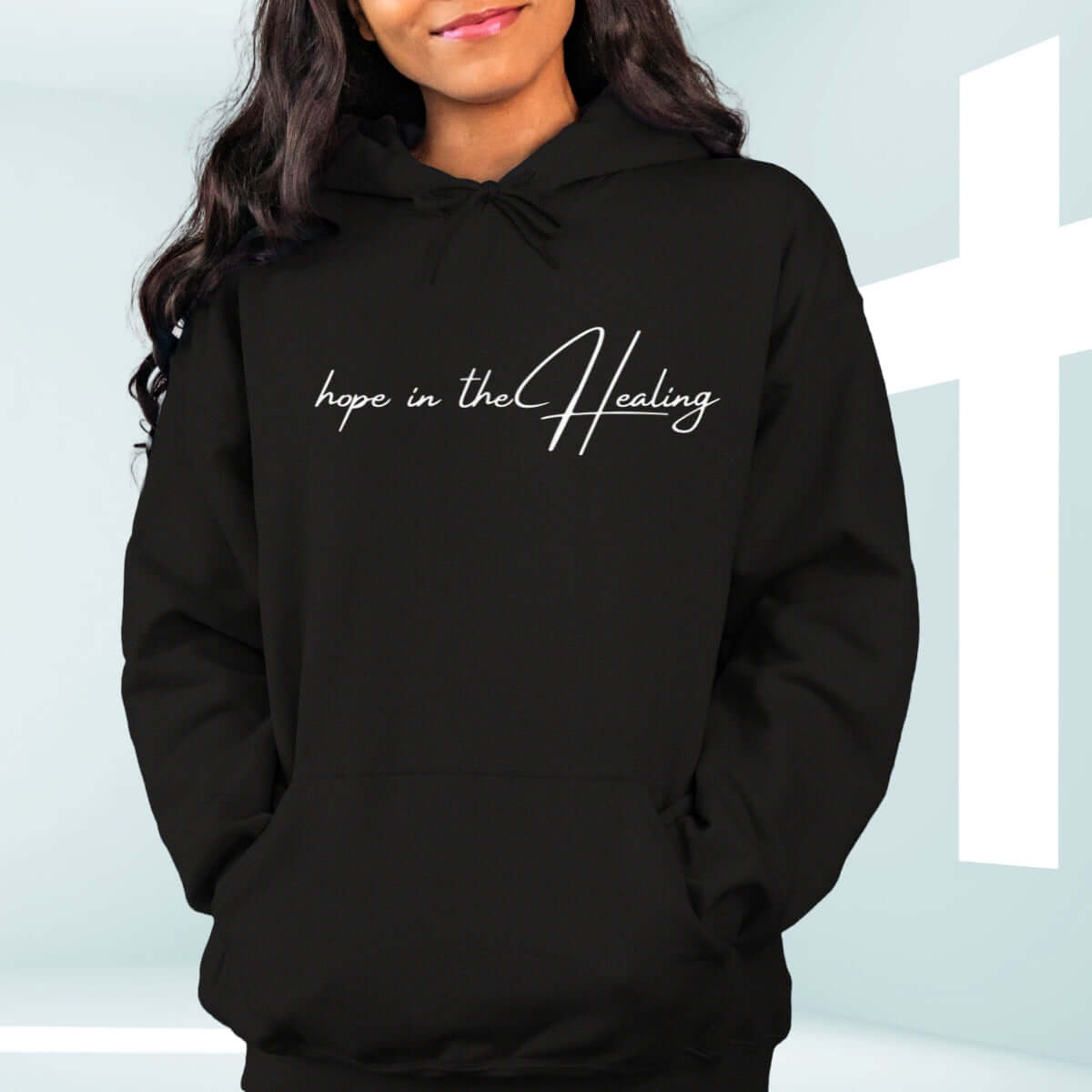 Christian hoodie "Hope in the Healing" on wooden background with flowers - faith-based get well soon gift