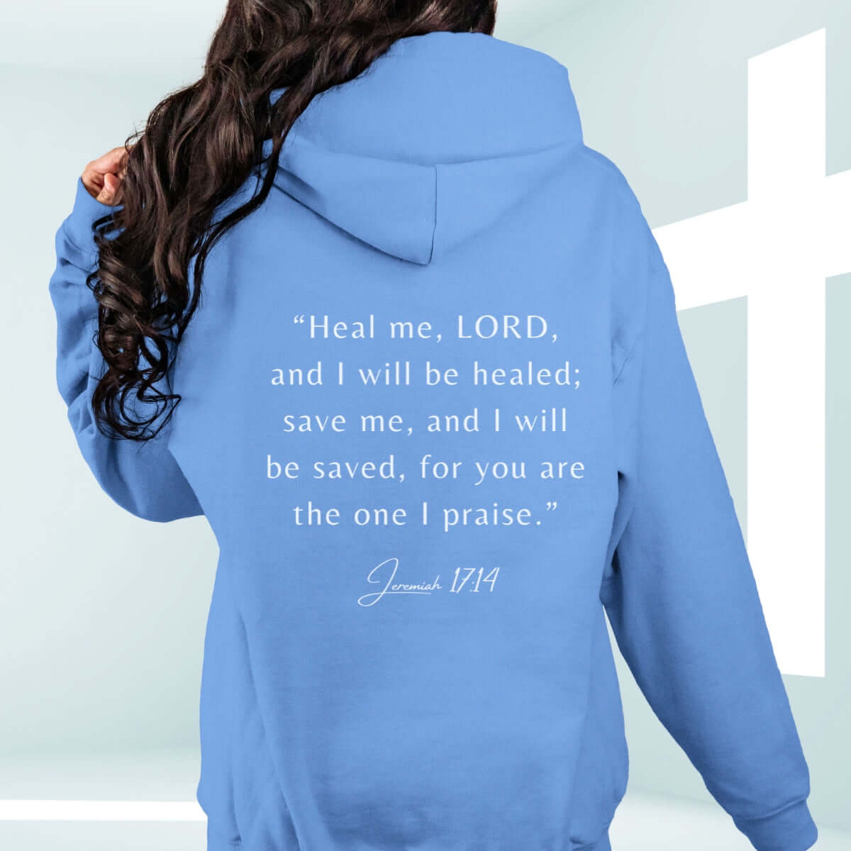 Blue Christian hoodie featuring Jeremiah 17:14 Bible verse, "Heal me, LORD, and I will be healed; save me, and I will be saved," on a floral background.