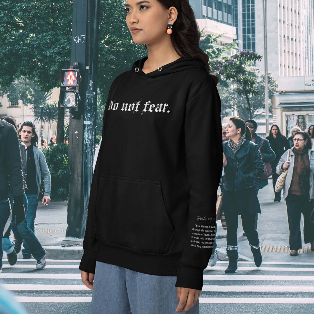 Black "Do Not Fear" Christian hoodie with Bible verse, inspirational faith-based graphic hooded sweatshirt in modern background