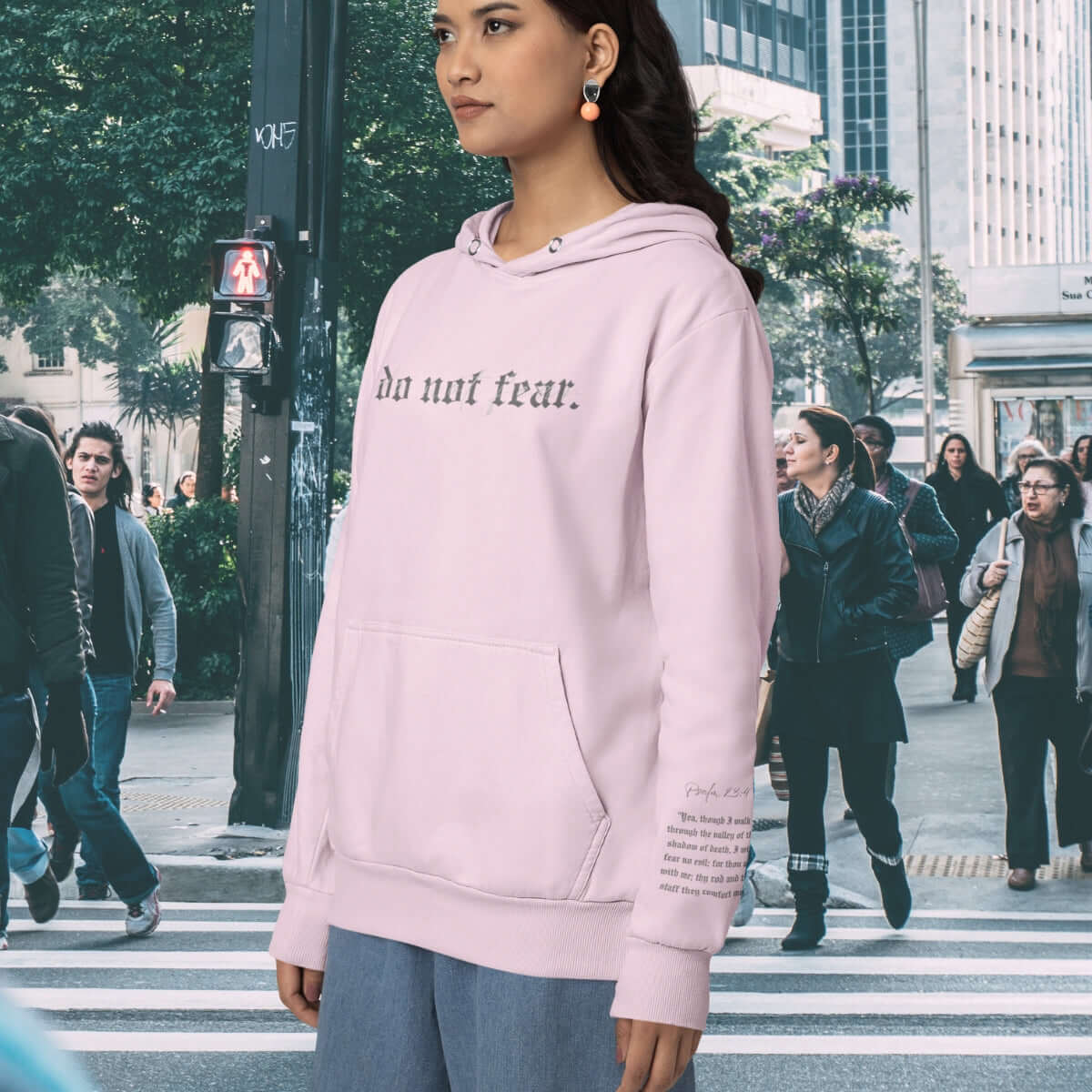 Pink Do Not Fear Christian hoodie with Bible verse, faith-based inspirational hooded sweatshirt in front of a cross backdrop