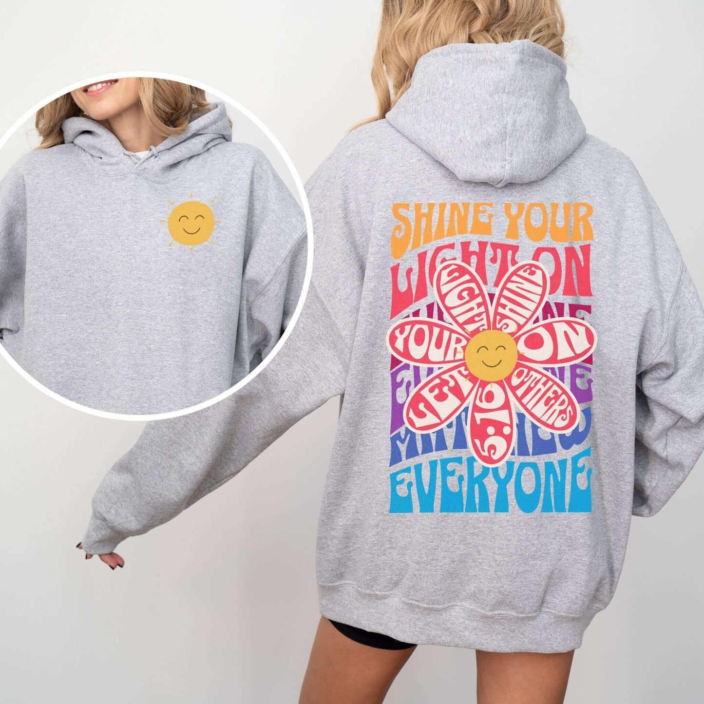 Christian hoodie "Shine Your Light" boho style with a colorful flower and smiley face design, promoting faith and inspiration through apparel.