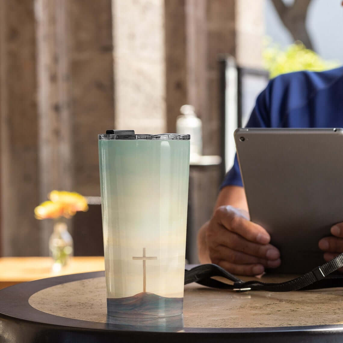 Insulated Christian tumbler with Cross Sky Yes Amen design on a table, ideal religious gift with stainless steel for hot or cold drinks