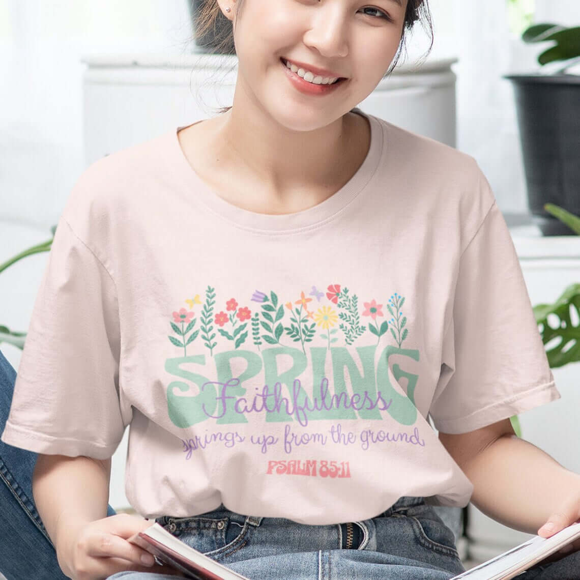 Woman wearing a Floral Faith Spring Flowers Christian T-Shirt with Bible verse design, celebrating faith and springtime.