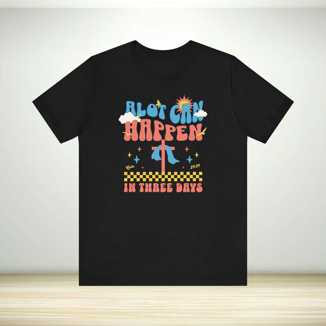 Christian Easter shirt with "Alot Can Happen In Three Days" print, black religious tee ideal for easter gifts, featuring bright colors and a cross