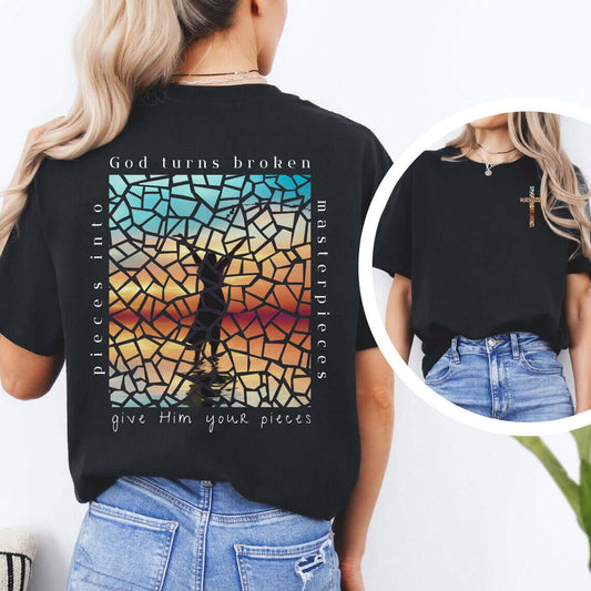 Woman wearing a black Christian t-shirt with Bible verse Ephesians 2:10 design saying "God turns broken pieces into masterpieces," front and back view.