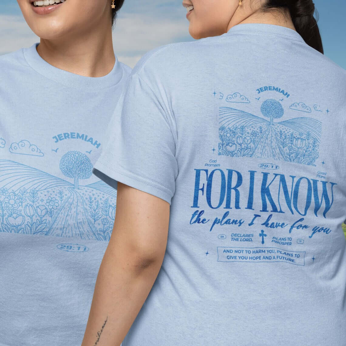 Two women wearing light blue "For I Know the Plans" Christian t-shirts with nature and Bible verse design.