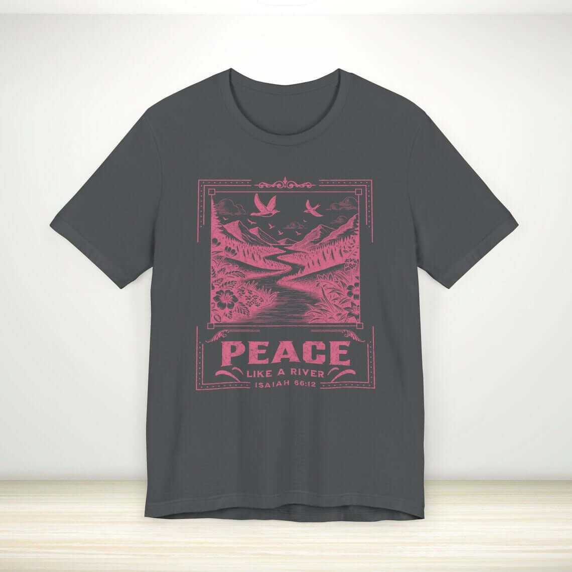 Christian tee with Peace Like A River Bible verse design, black shirt with pink nature-themed print. Perfect faith apparel for witnessing.