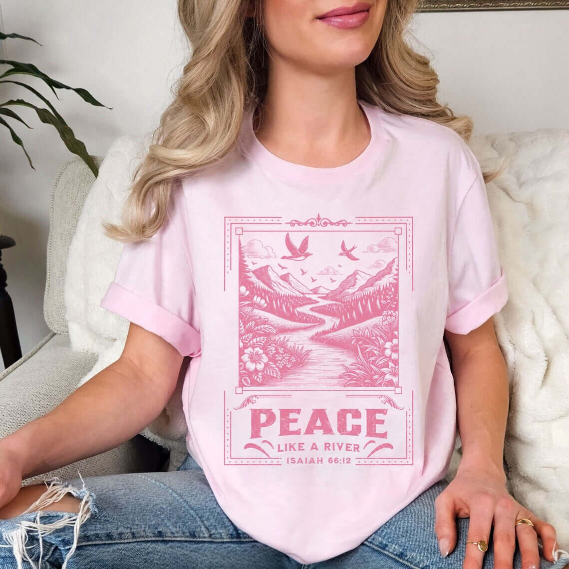 Woman wearing Peace Like A River Christian tee with Bible verse, religious shirt from Thankfully Christian, faith apparel promoting peace, pink color