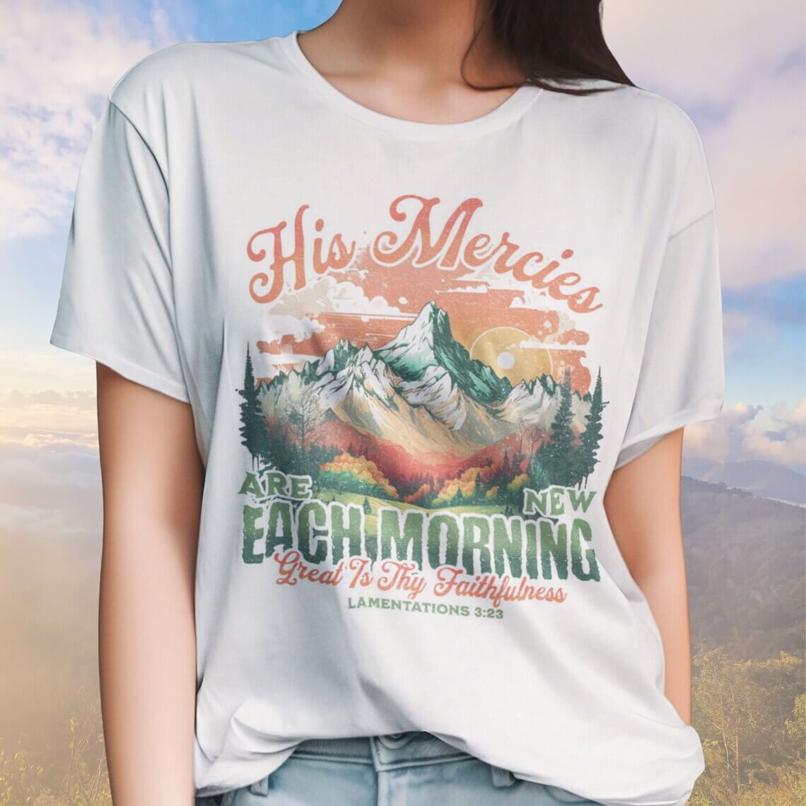 Woman wearing "His Mercies Are New Each Morning" Christian t-shirt with Bible verse, boho style, and mountain design.