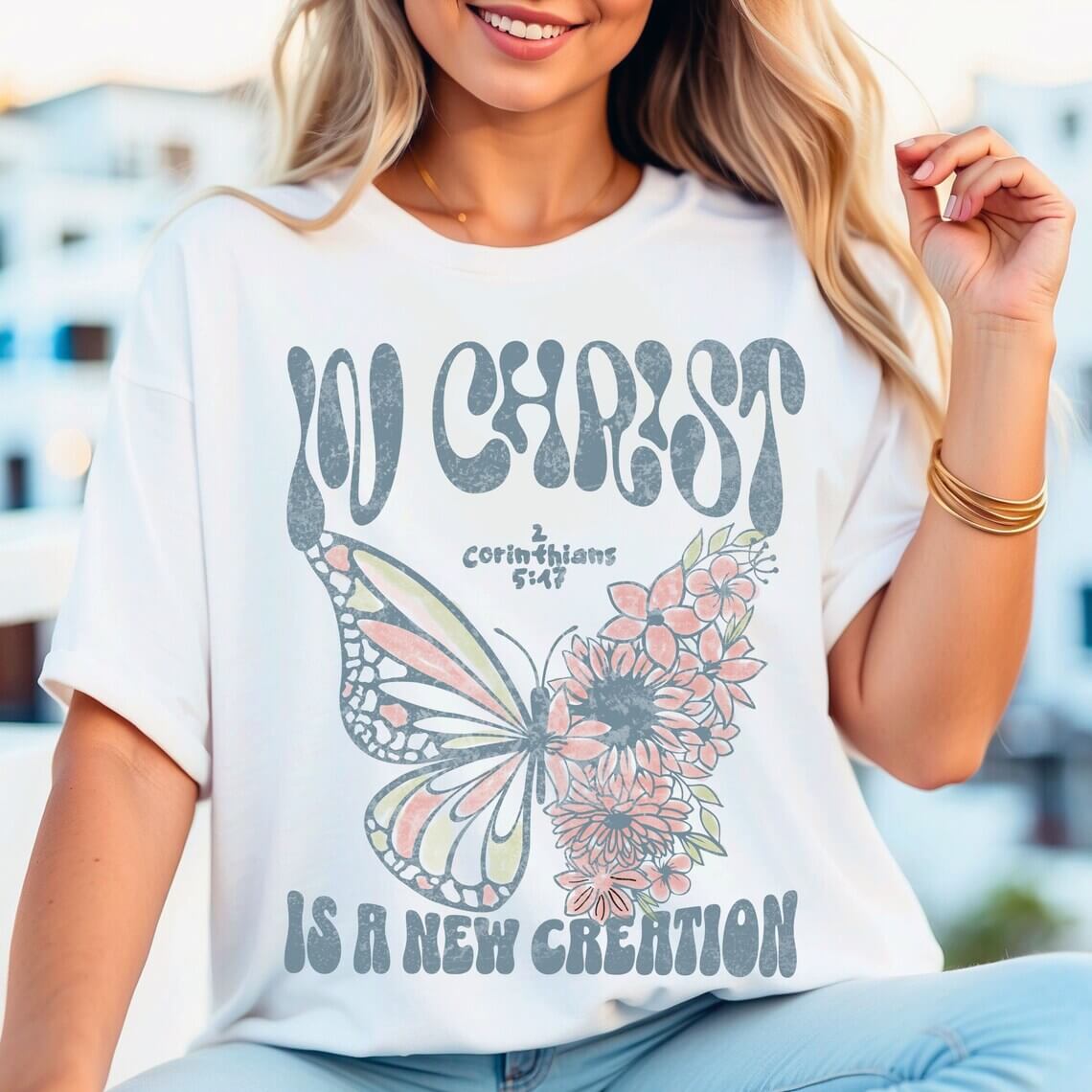 Woman wearing "In Christ Is A New Creation" butterfly Christian shirt, featuring Bible verse, stylish Jesus tee perfect for faith sharing.