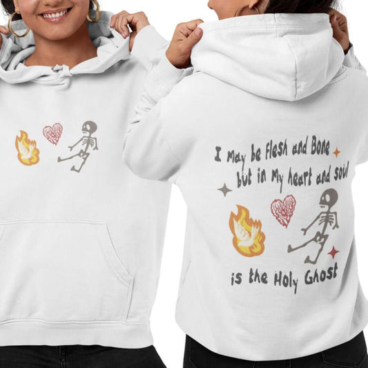 Woman wearing Christian Halloween hoodie with a skeleton, heart, and flame design, featuring scripture text "I May Be Flesh and Bone."