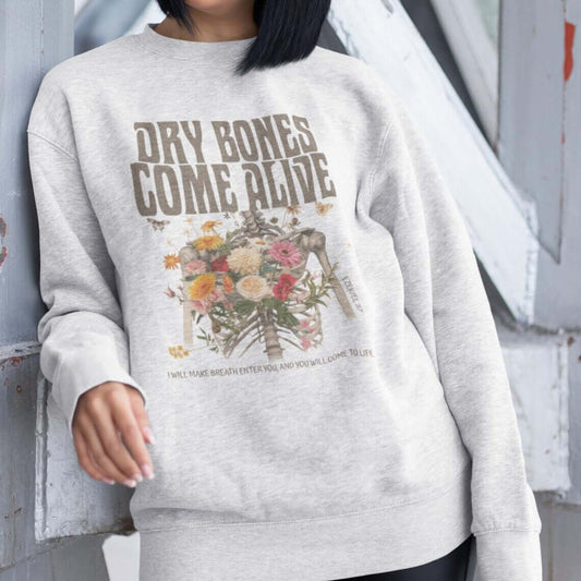 Christian Halloween sweatshirt with "Dry Bones Come Alive" design, featuring skeleton and floral motif, inspired by Ezekiel 37.