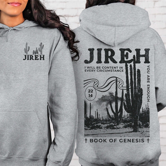 Gray Jireh Christian hoodie with Bible verse, cactus design on the back, and "Book of Genesis" text, worn by a model.