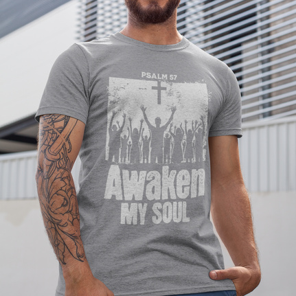 a person wearing a gray t-shirt with the words "awaken my soul" on it